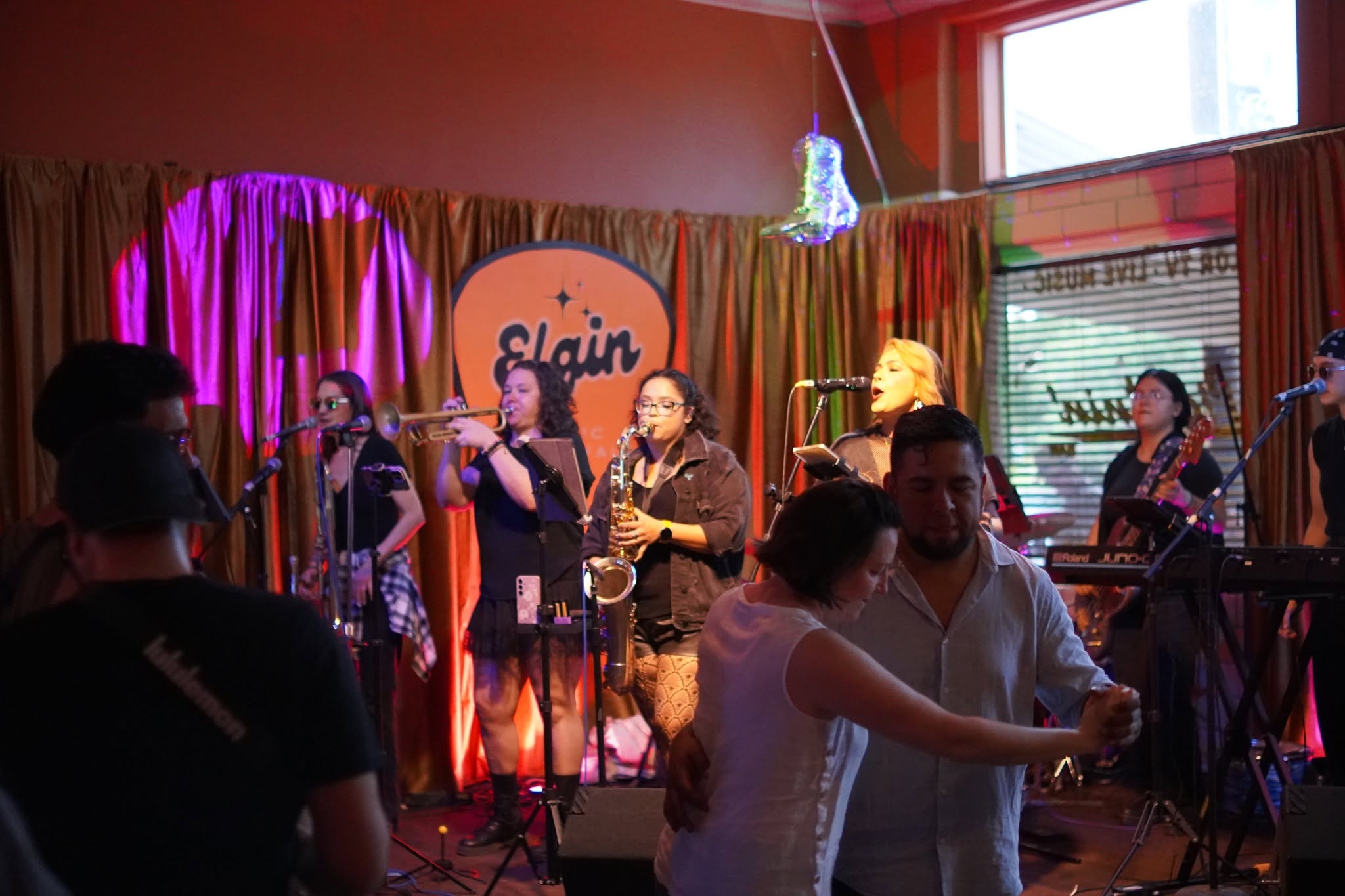 Festivalgoers dancing in front of a live band
